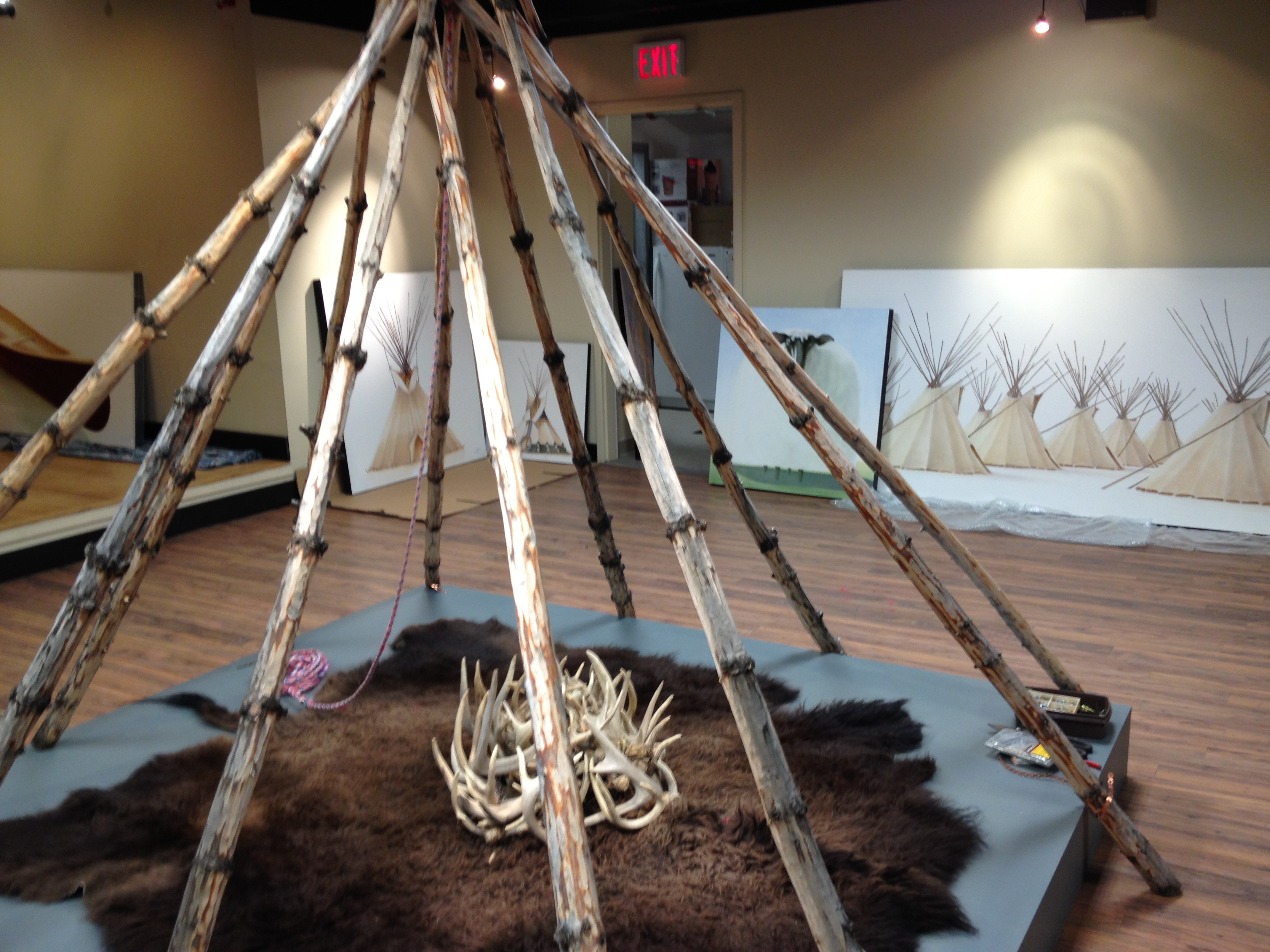 Setting up the CAMP exhibition by Janice Tanton at the Okotoks Art Gallery